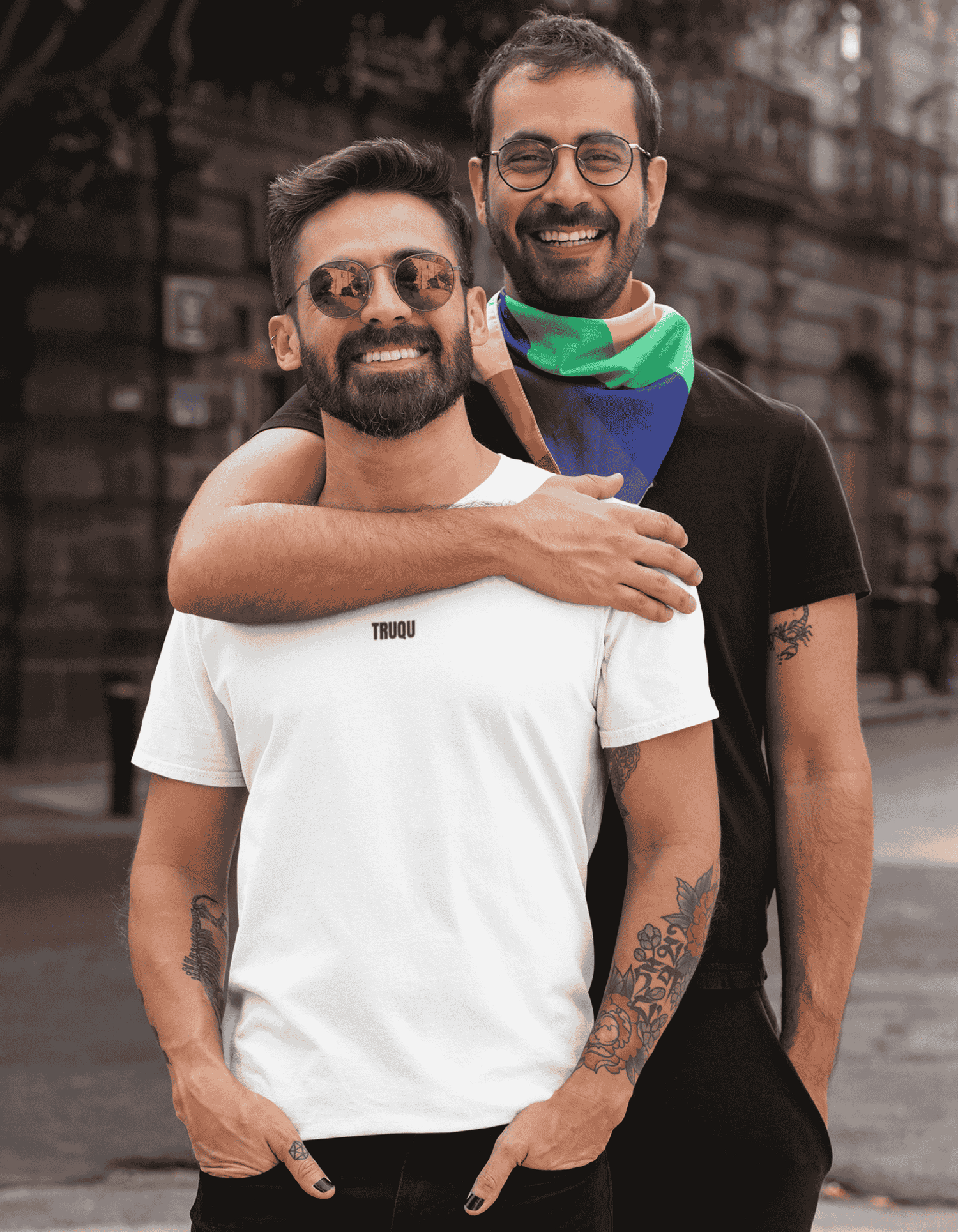 Two men hugging outdoors with a blurred background truqu